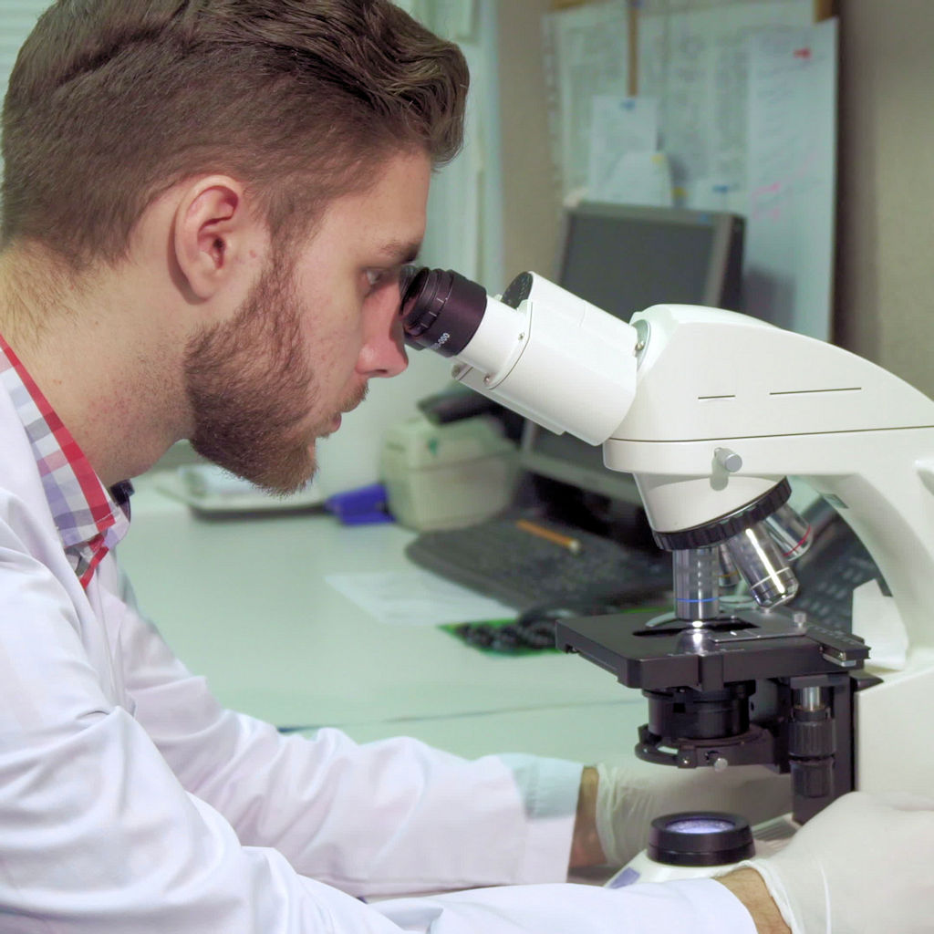 Skilled Worker at Microscope